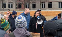 Hailey Kenward speaking into a megaphone in a protest. 