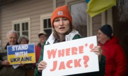 A woman holds a sign that says "Where's Jack?" 