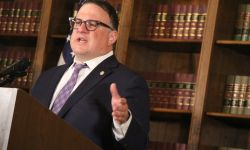 Michigan state House Speaker Matt Hall speaks at a podium