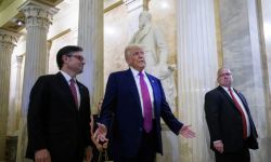 President Donald Trump stands next to Speaker of the House Mike Johnson.
