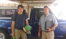 Bradford Gille and Shane Gille stand in front of a truck.