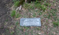 A gravestone is seen in the ground