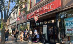 Shoppers stream out of a Cherry Republic store in downtown Traverse City