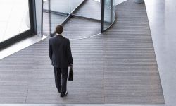 man standing in front of a revolving door