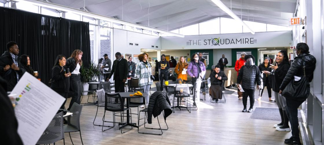 People gather in a large open room that is meant to serve as a refuge during climate disasters